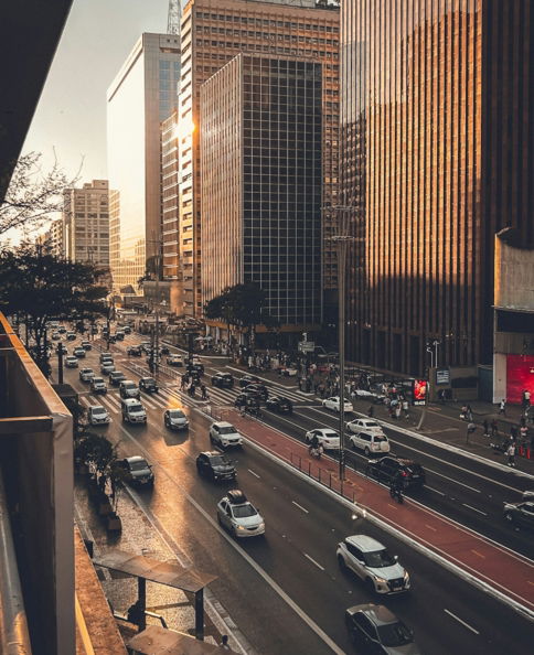 A city street filled with lots of traffic next to tall buildings